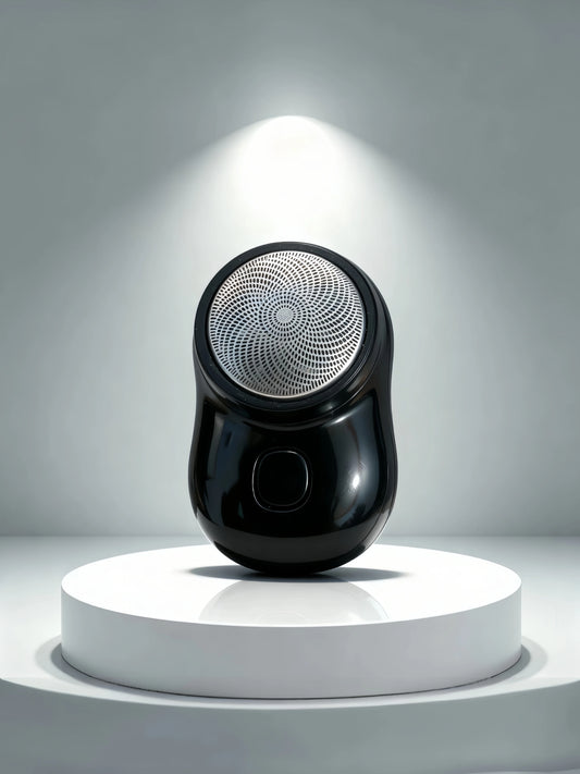 Black electric shaver on a white pedestal with a gray background